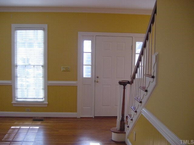 3428 Harden Road Raleigh, NC 27607 - Photo 8 of 12 a view of an entryway with wooden floor and door