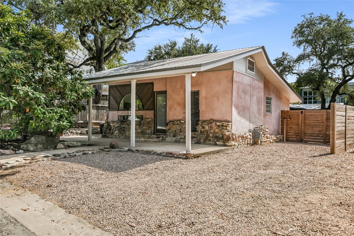 a view of a house with a backyard and a tree
