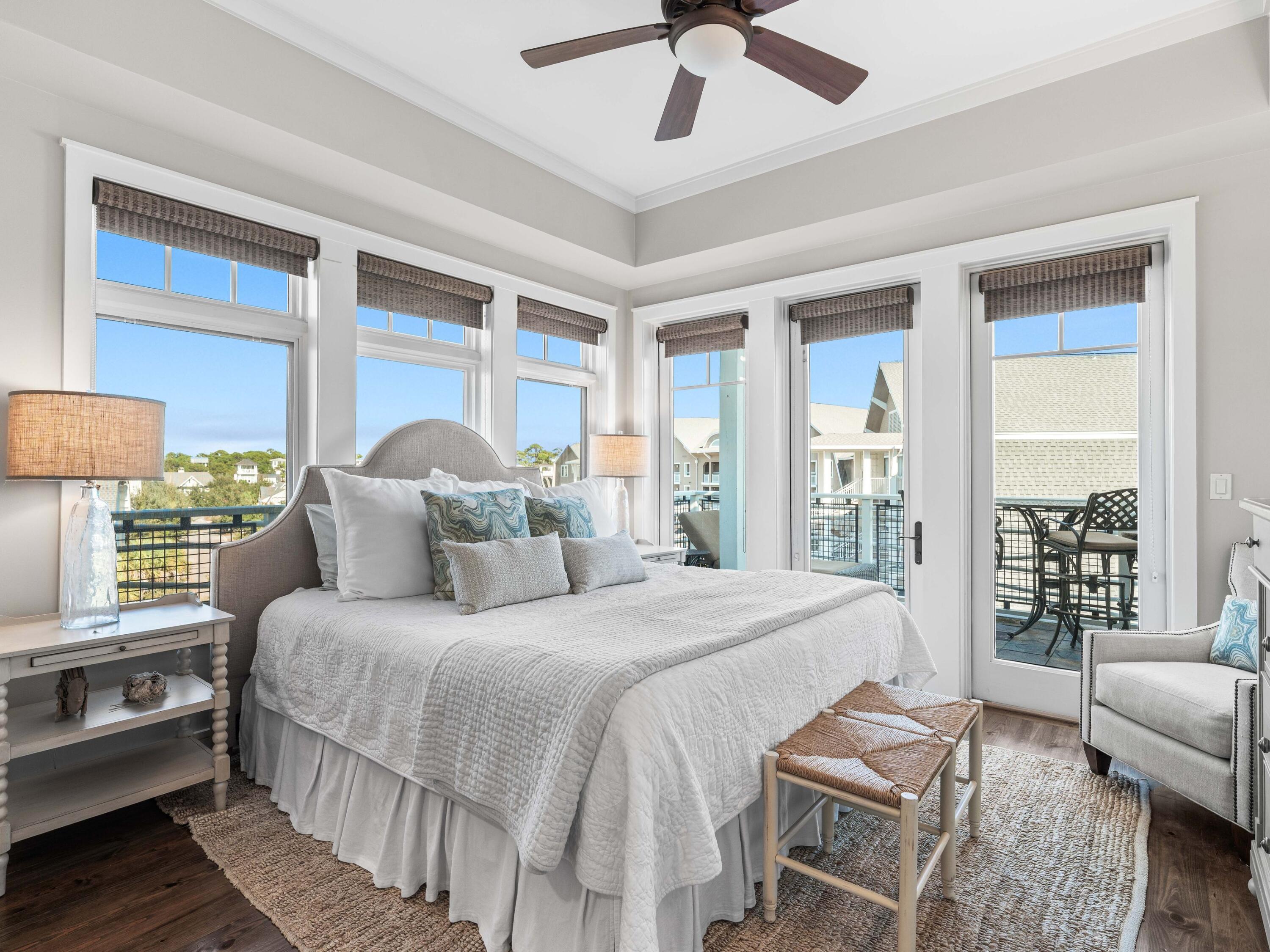 99 Compass Point Way, Unit 401 Watersound, FL 32461 - Photo 12 of 33 a bedroom with a bed couch and a large window