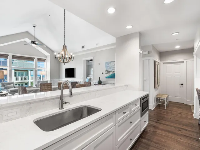 a spacious kitchen with stainless steel appliances a sink and a large window