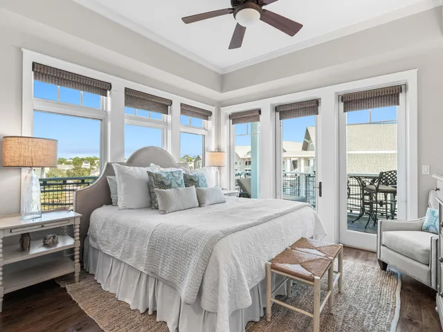 a bedroom with a bed couch and a large window