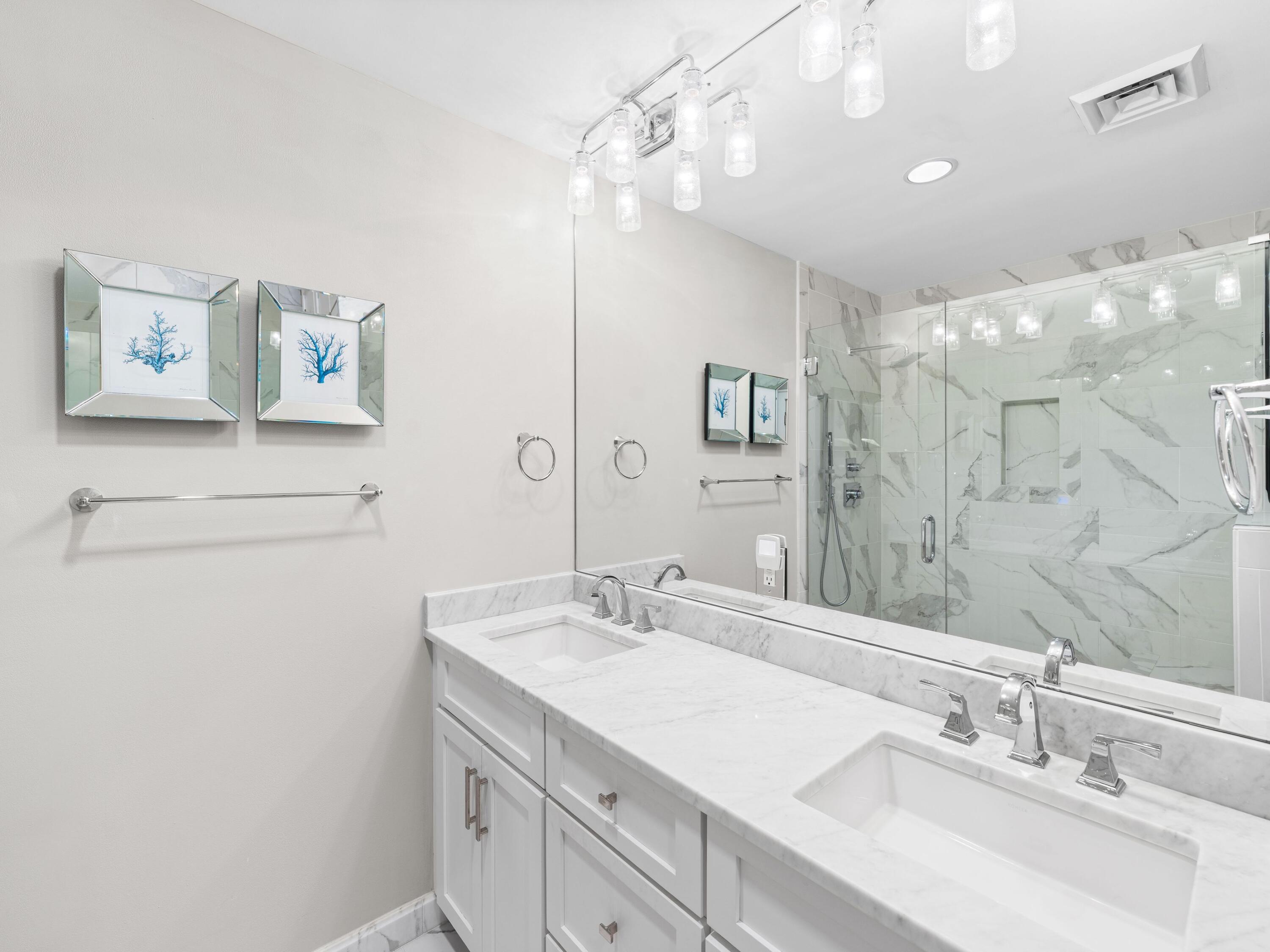 99 Compass Point Way, Unit 401 Watersound, FL 32461 - Photo 14 of 33 a bathroom with a sink vanity and a mirror
