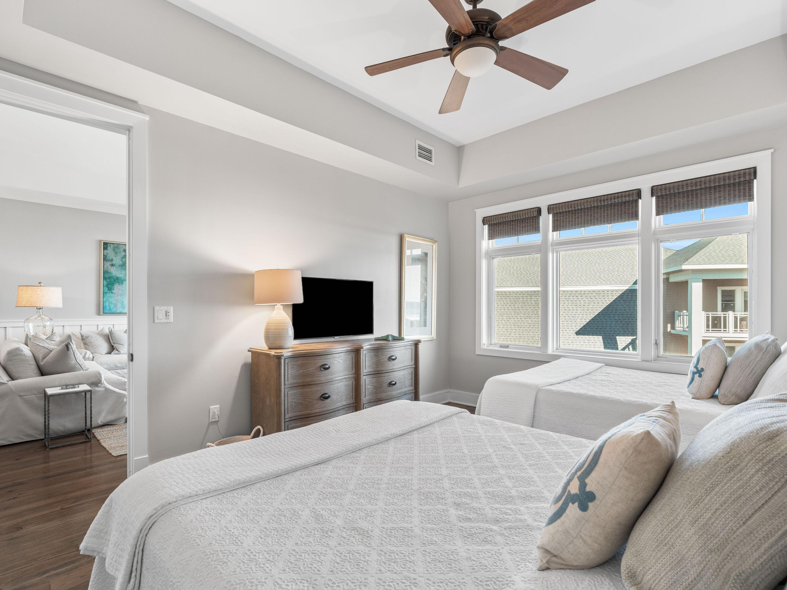 99 Compass Point Way, Unit 401 Watersound, FL 32461 - Photo 18 of 33 a bedroom with a bed and a large window