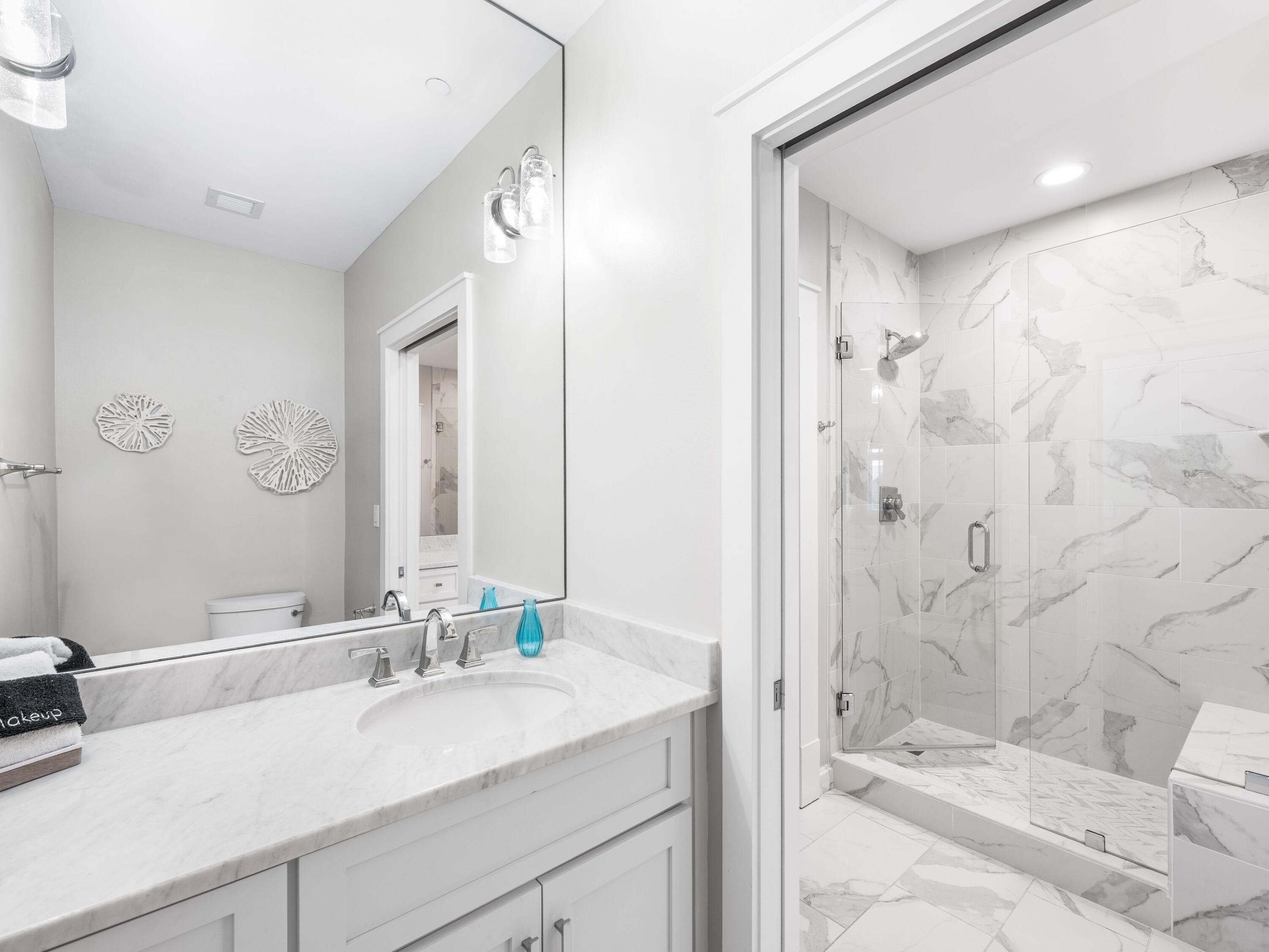 99 Compass Point Way, Unit 401 Watersound, FL 32461 - Photo 19 of 33 a bathroom with a sink and a mirror
