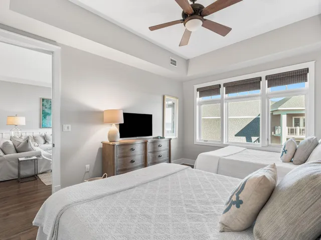 a bedroom with a bed and a large window