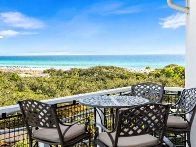 a view of a chairs and table on the roof deck
