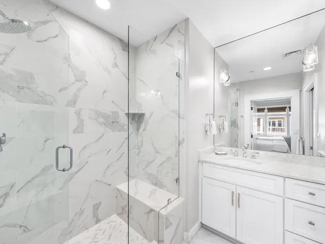 a bathroom with a double vanity sink mirror and shower