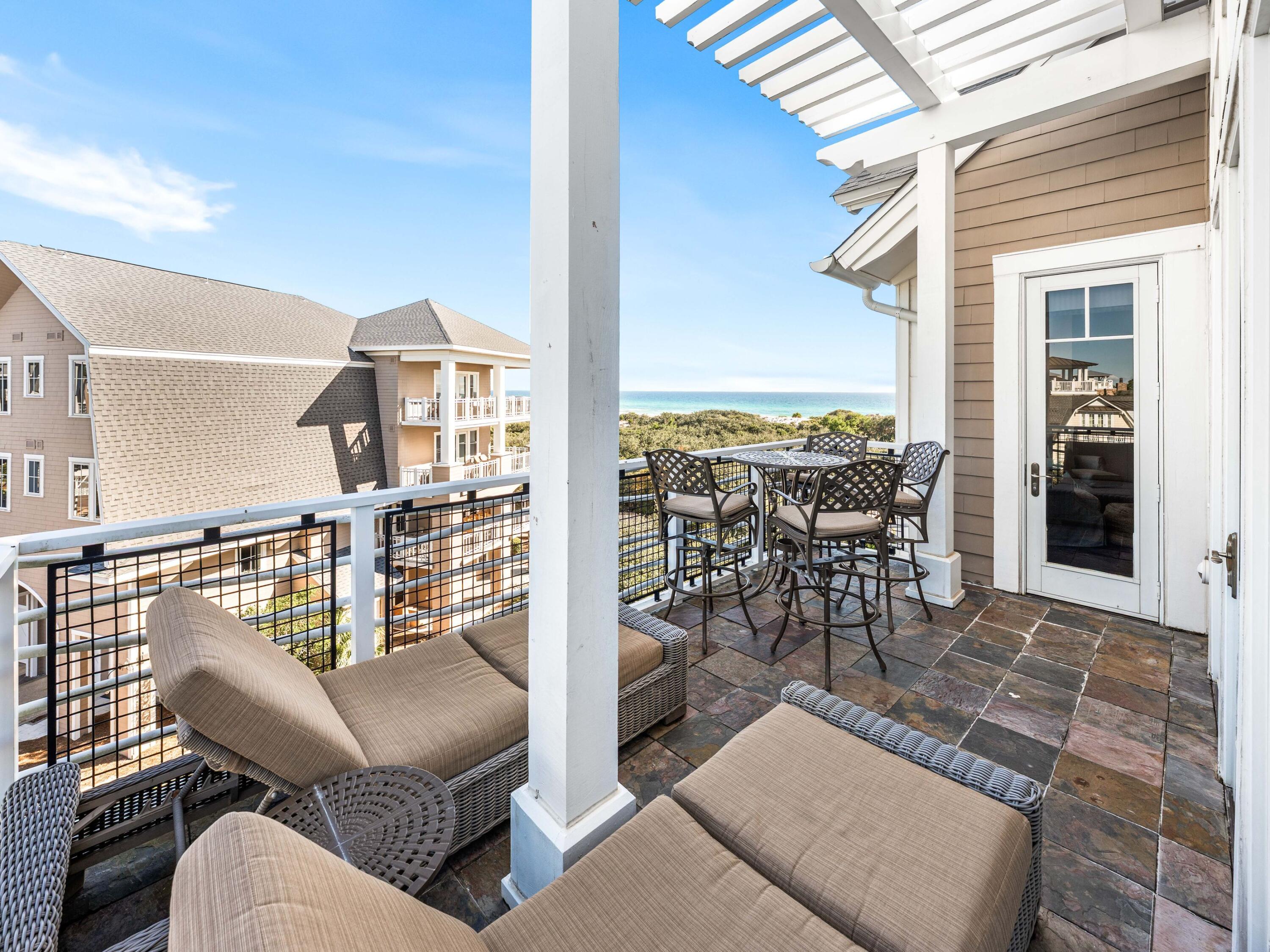 99 Compass Point Way, Unit 401 Watersound, FL 32461 - Photo 21 of 33 a view of a patio with couches table and chairs