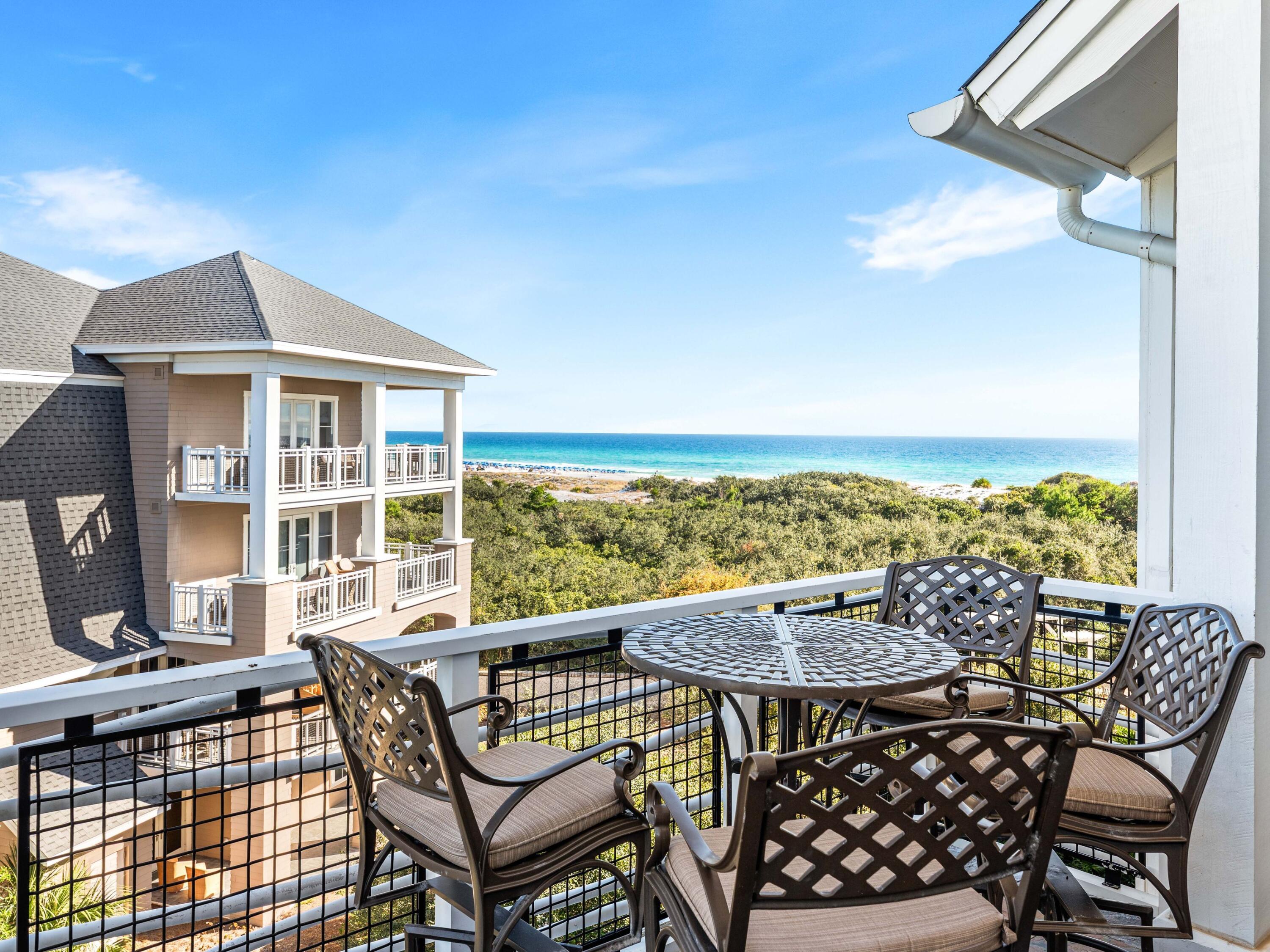99 Compass Point Way, Unit 401 Watersound, FL 32461 - Photo 22 of 33 a view of a chairs and table on the terrace
