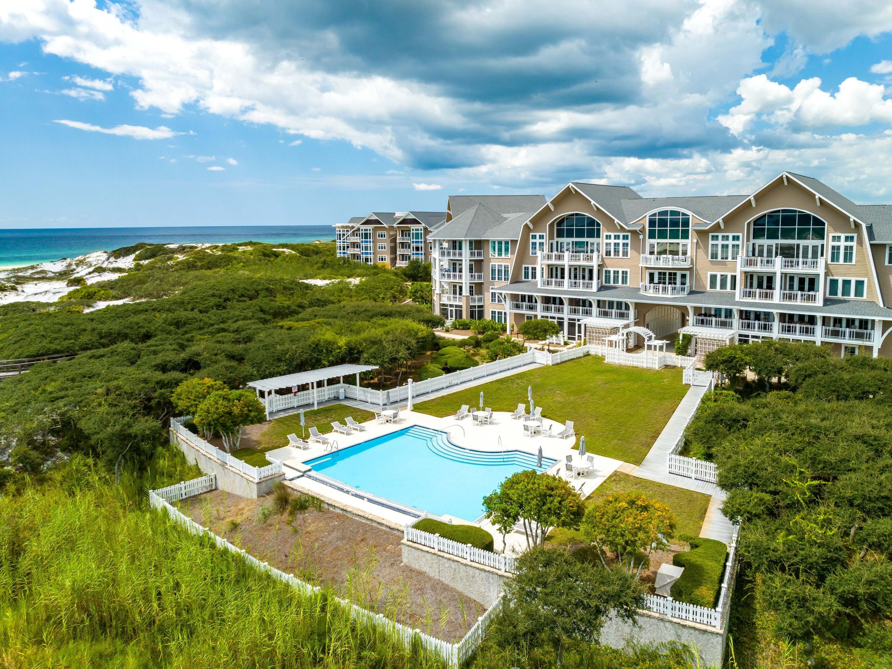 99 Compass Point Way, Unit 401 Watersound, FL 32461 - Photo 25 of 33 a view of a house with swimming pool and sitting area