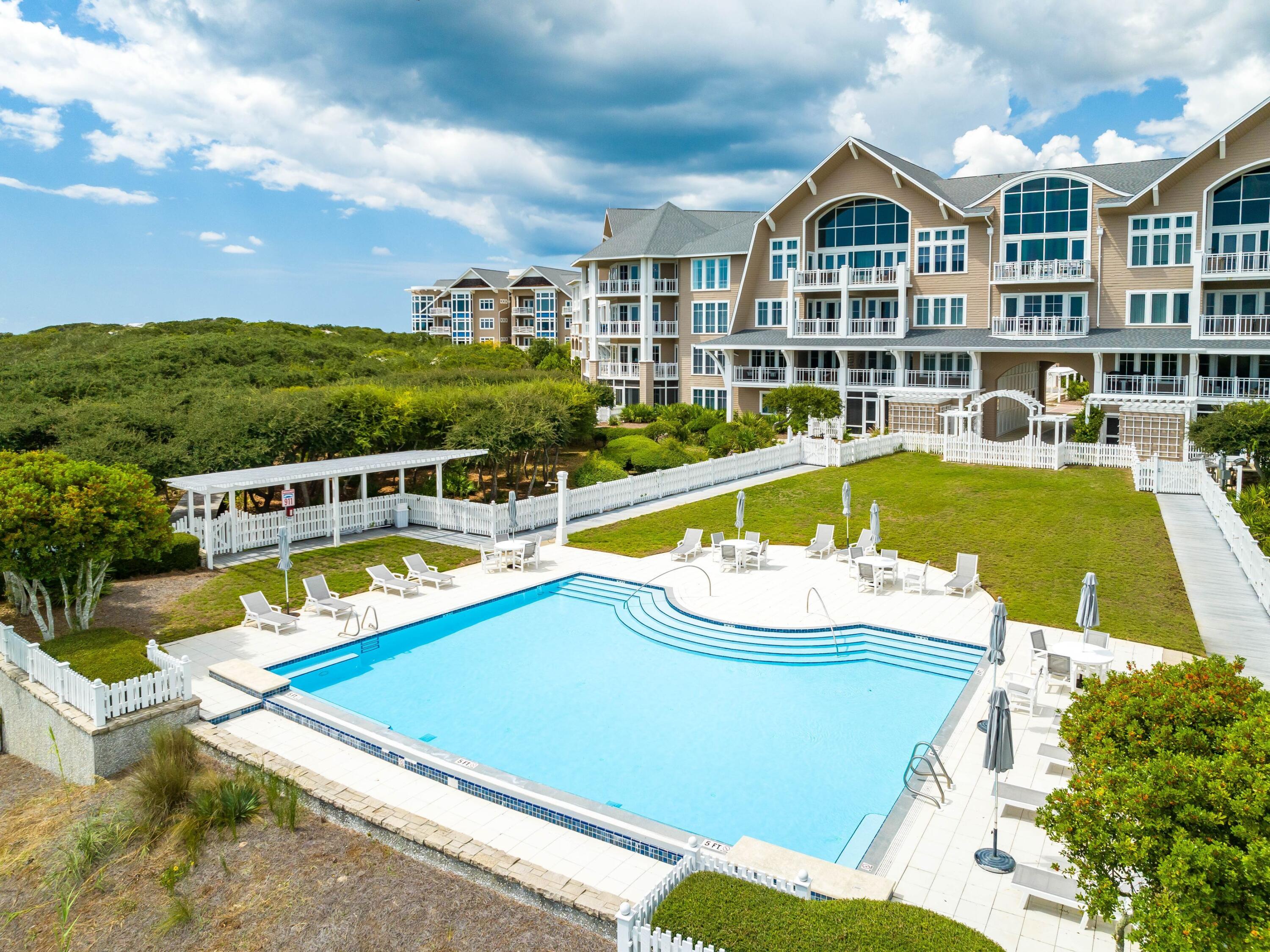 99 Compass Point Way, Unit 401 Watersound, FL 32461 - Photo 29 of 33 a view of a swimming pool and a yard