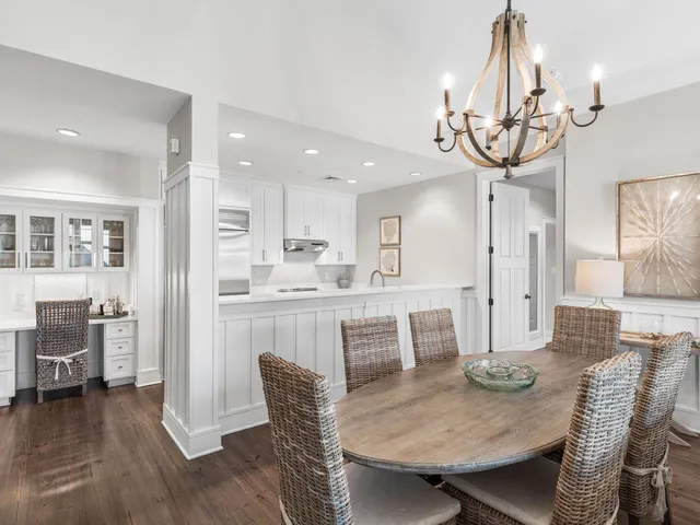 a view of a dining room with furniture wooden floor and chandelier