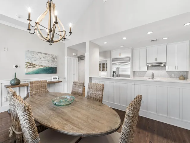 a view of a dining room with furniture wooden floor and chandelier
