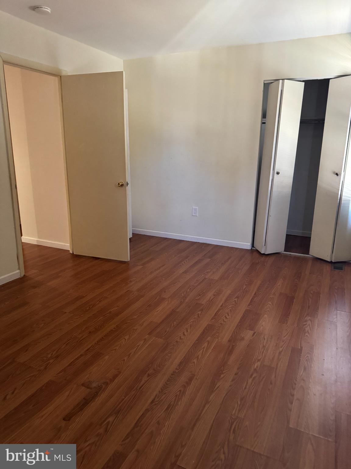 1823 Jaybird Court Severn, MD 21144 - Photo 7 of 21 an empty room with wooden floor and glass door