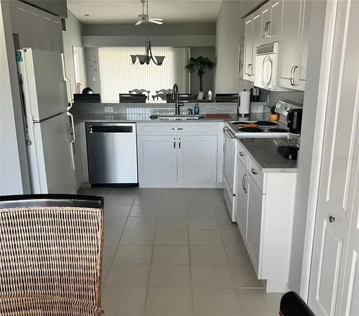 a kitchen with stainless steel appliances a refrigerator a sink a stove a refrigerator and cabinets