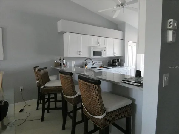 a kitchen with a table chairs sink and cabinets
