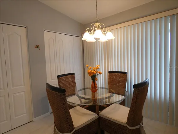 a dining room with furniture a chandelier and window