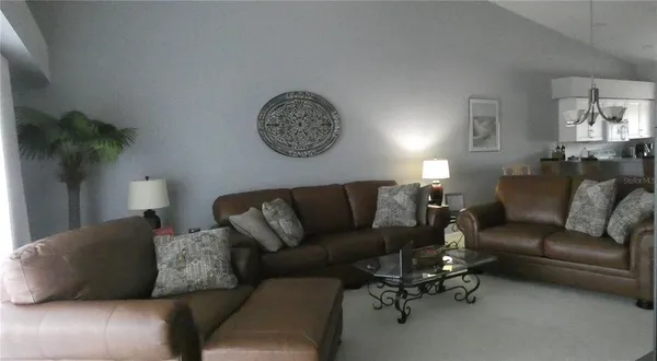a living room with furniture and a lamp