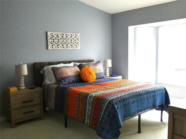 a bedroom with a bed and a window