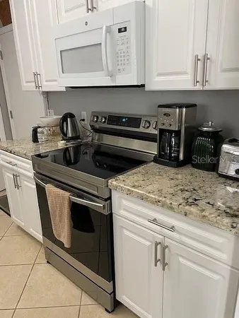 a stove top oven sitting inside of a kitchen