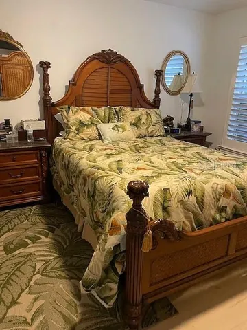 a bedroom with a bed and a painting on the wall