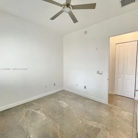 a view of a livingroom with furniture staircase and a floor to ceiling window