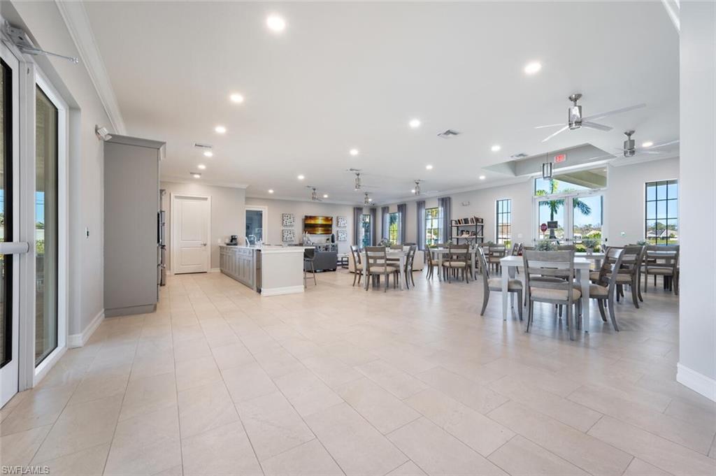 1066 Enbrook Loop Naples, FL 34114 - Photo 5 of 14 a dining hall with stainless steel appliances lots of furniture a table and chairs