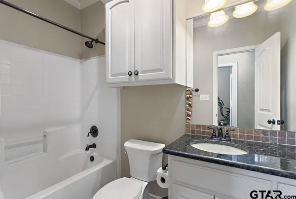 a bathroom with a sink a toilet and a mirror