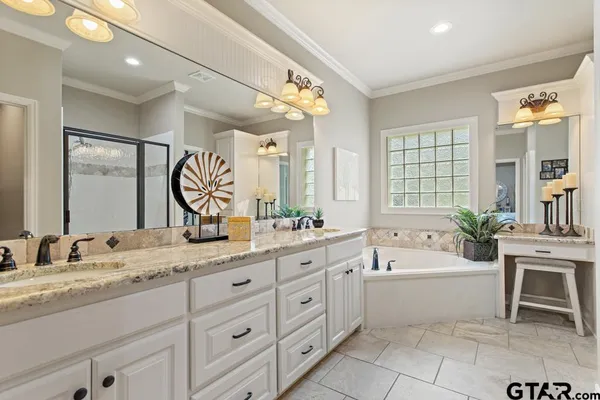a spacious bathroom with a tub shower and sink