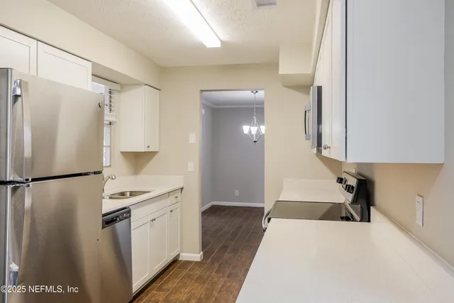 a kitchen with a refrigerator a sink and dishwasher