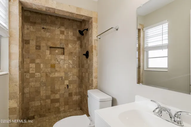 a bathroom with a toilet and shower