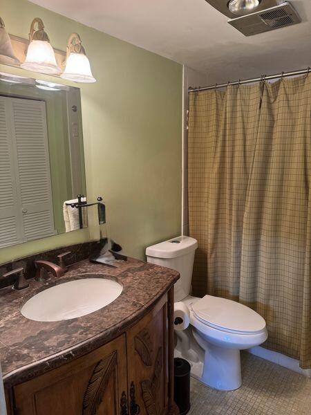 5401 Northwest 2nd Avenue, Unit 224 Boca Raton, FL 33487 - Photo 11 of 18 a bathroom with a granite countertop toilet sink and mirror