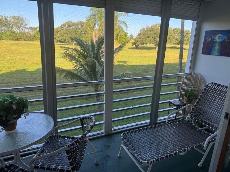 5401 Northwest 2nd Avenue, Unit 224 Boca Raton, FL 33487 - Photo 14 of 18 a room with furniture and a floor to ceiling window