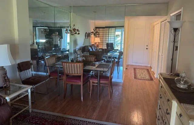 a dining room with furniture and wooden floor