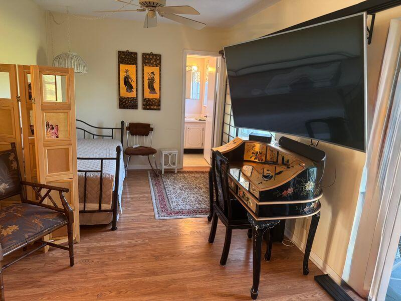 5401 Northwest 2nd Avenue, Unit 224 Boca Raton, FL 33487 - Photo 5 of 18 a living room with furniture and a flat screen tv
