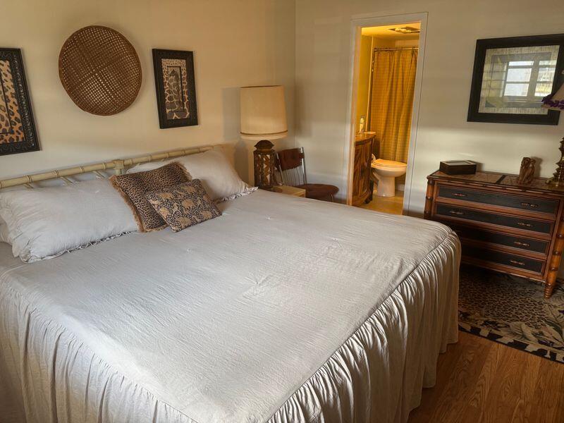 5401 Northwest 2nd Avenue, Unit 224 Boca Raton, FL 33487 - Photo 9 of 18 a bedroom with a bed and a lamp