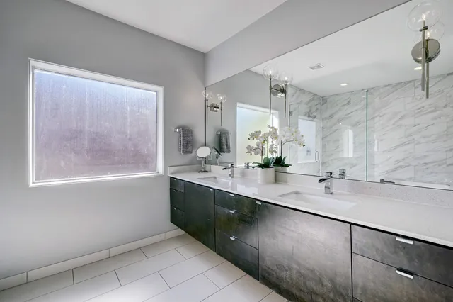 a spacious bathroom with a sink a mirror and a bathtub