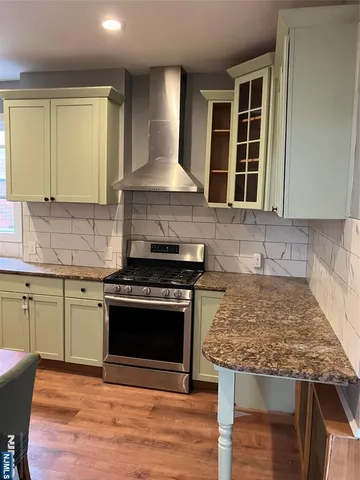 a kitchen with granite countertop a stove and a sink