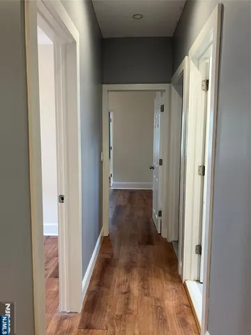 a view of a room with wooden floor
