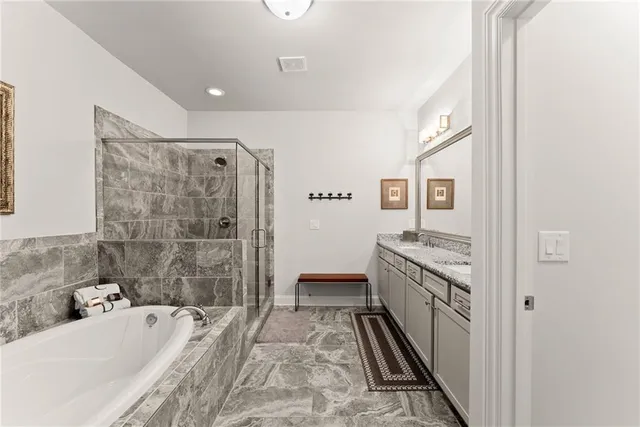 a bathroom with a bathtub and a shower