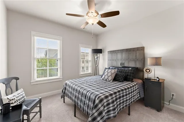 a bedroom with bed and a chandelier