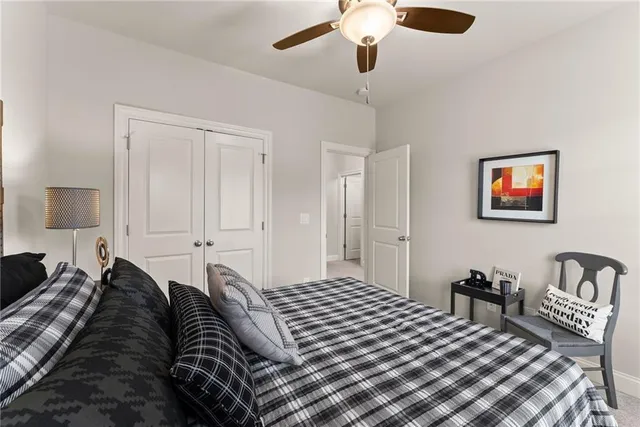 a bedroom with a large bed and a chandelier