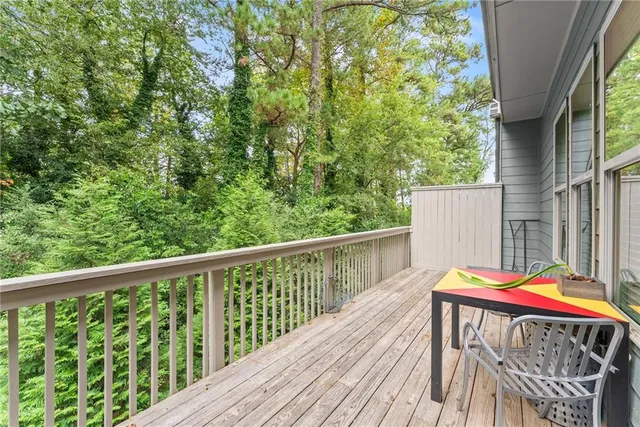 a balcony with wooden floor and furniture