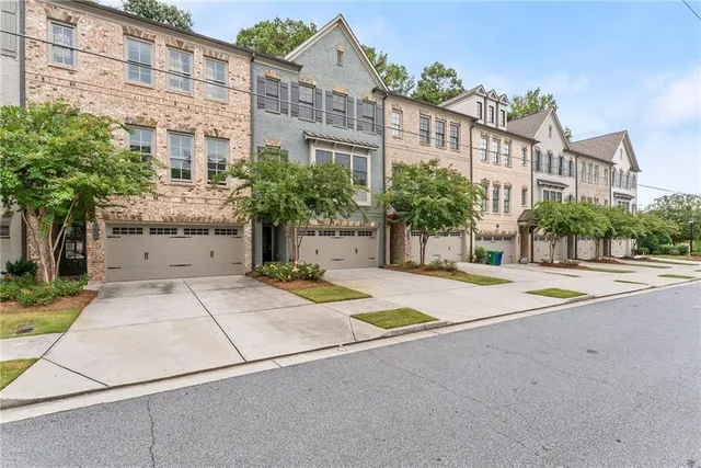 a front view of a house with plants