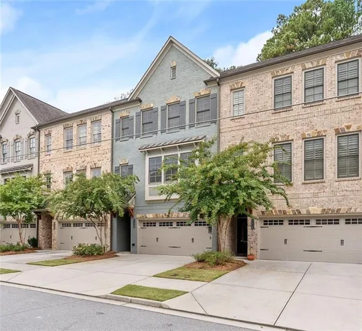 a view of a patio with couches table and chairs and potted plants