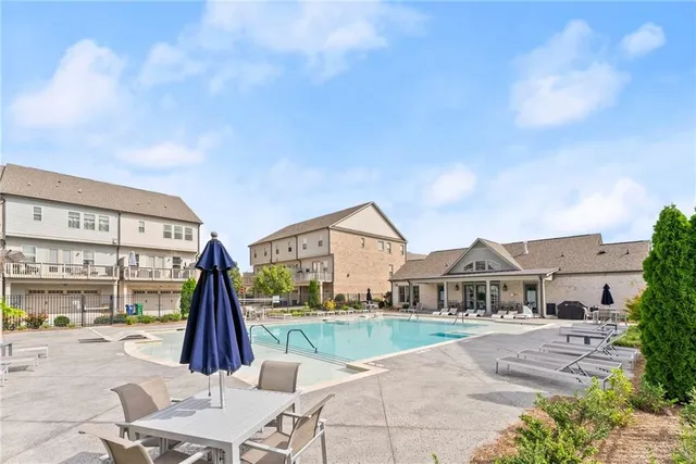a view of a grassy field with trees in the background