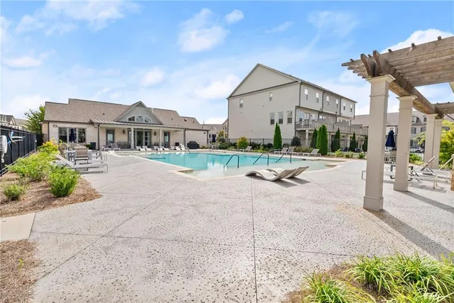 a view of a house with backyard and sitting area