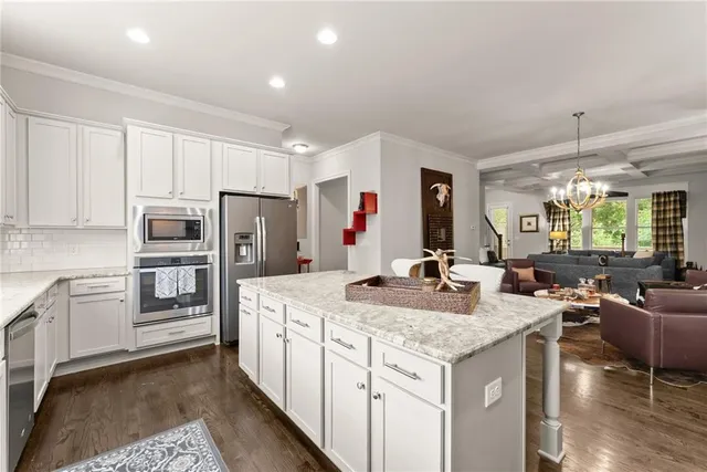 a kitchen with stainless steel appliances granite countertop a stove and a refrigerator