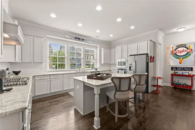 a living room with furniture chandelier and a window