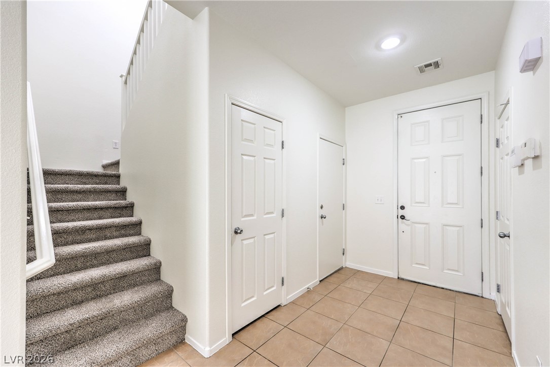 10939 Paradise Road Henderson, NV 89052 - Photo 4 of 36 A welcoming entryway with a staircase to the upper level and convenient closet space.